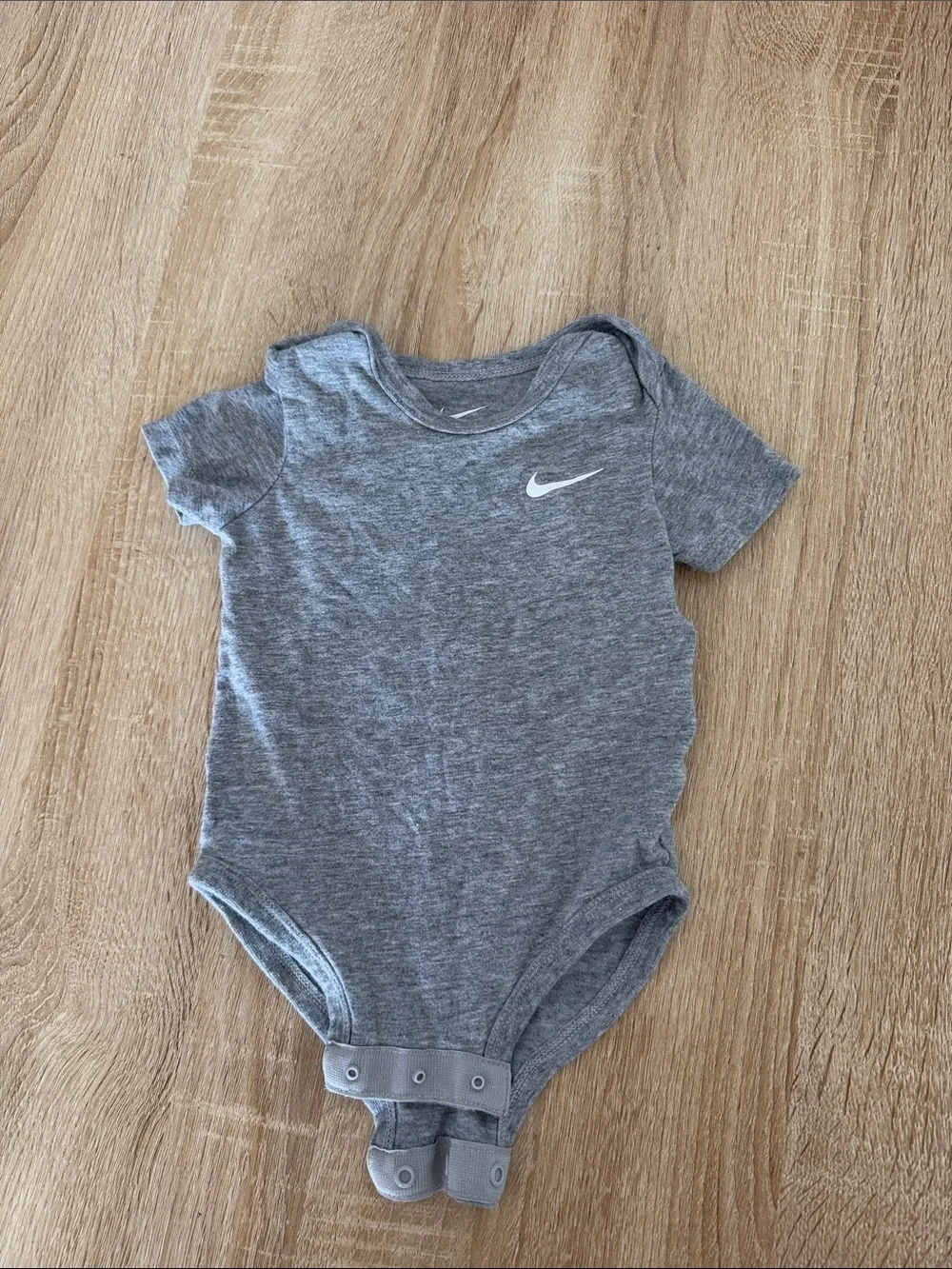Nike Heather Gray Infant Bodysuit with White Swoosh